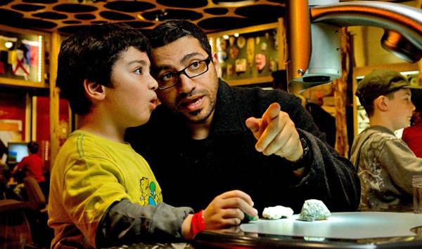 A father and son exploring exhibits together at Discovery Place