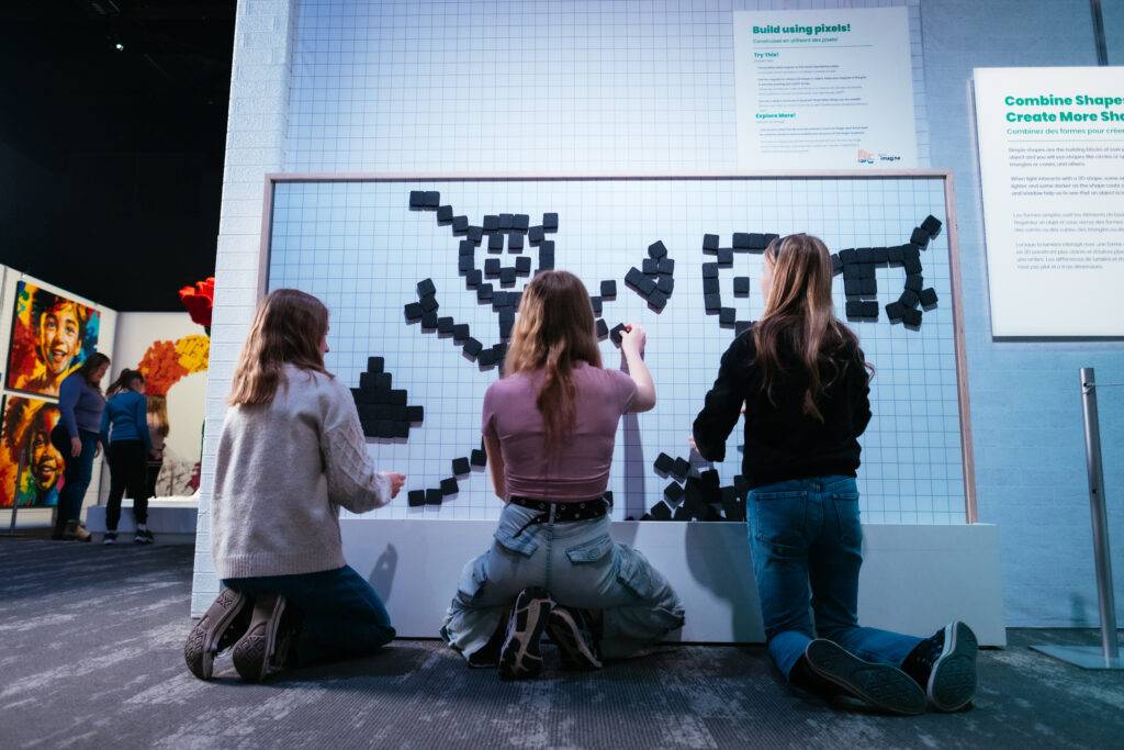 Visitors building pixel art with LEGO bricks