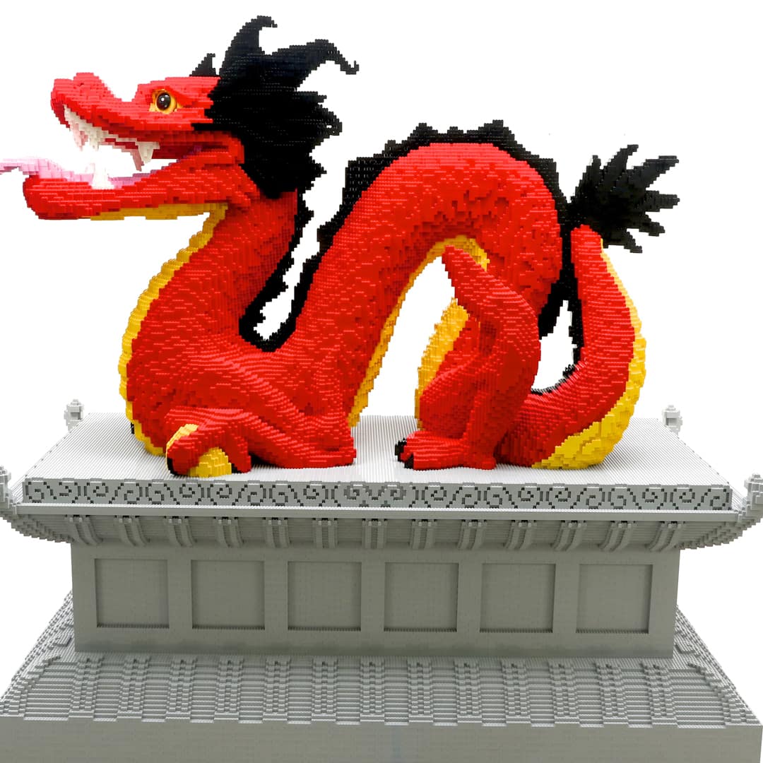 Red LEGO dragon sculpture atop a pagoda