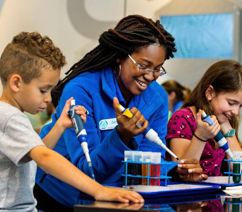 Discovery Place staff member doing science experiments with children