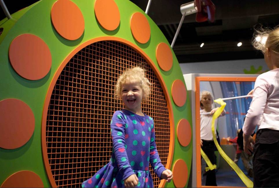 Girl laughing near play structure