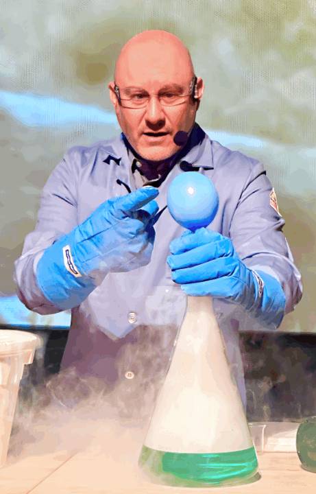 Museum educator performing a science demonstration