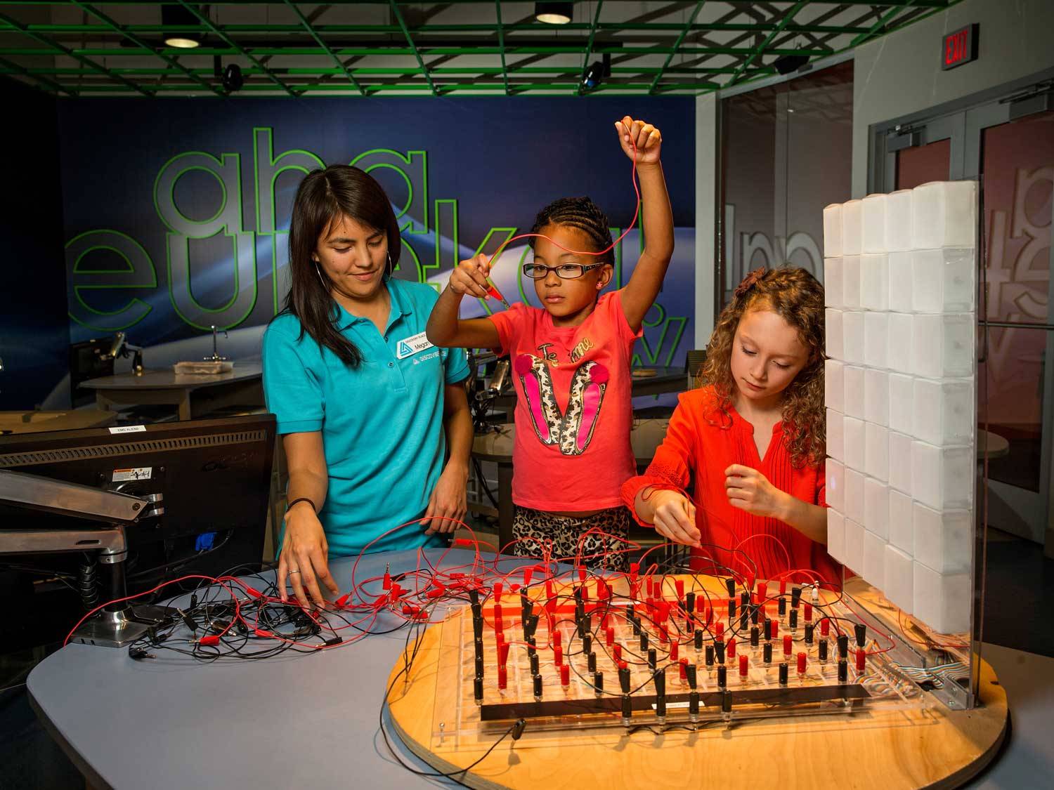 Kids doing hands-on STEM activities in a museum class