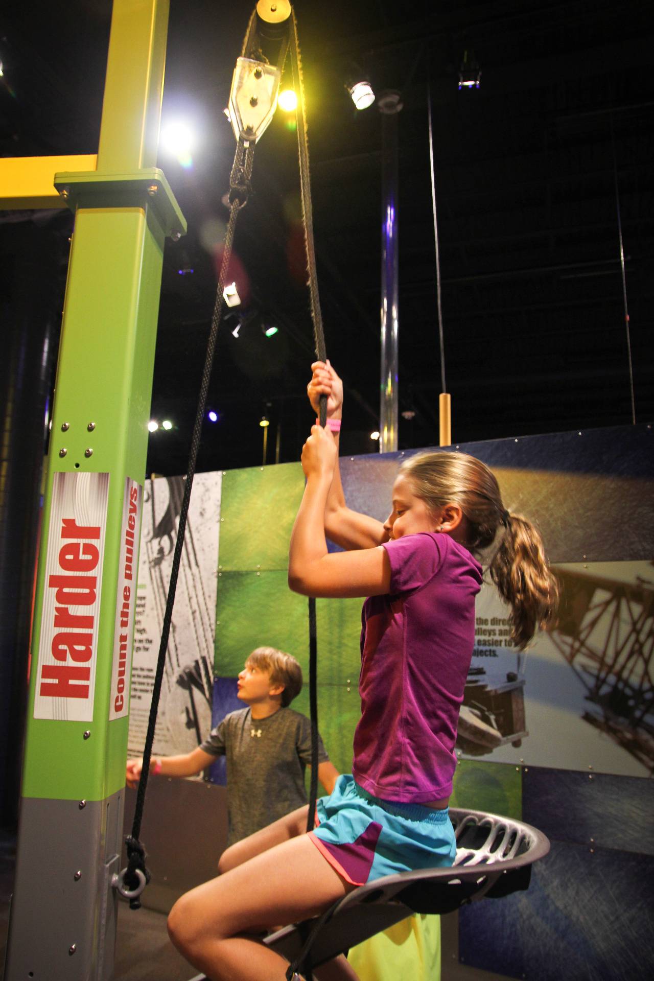 Girl using the Pulley Chair exhibit