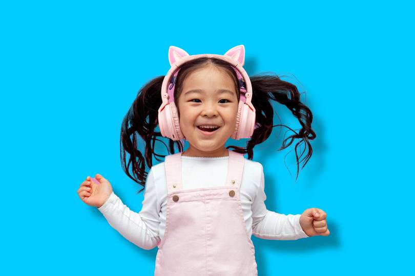 Child wearing noise-canceling headphones exploring a calm museum exhibit